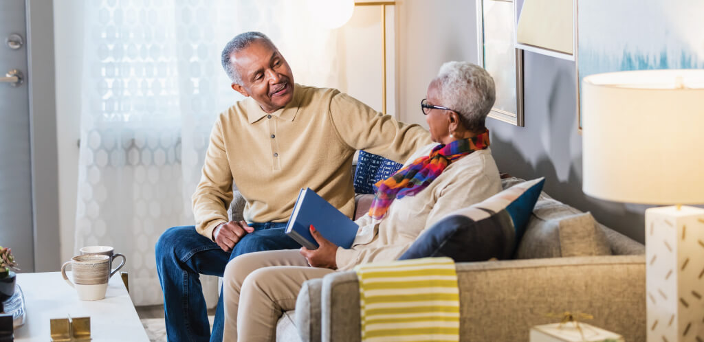 Happy couple sitting on the couch and smiling