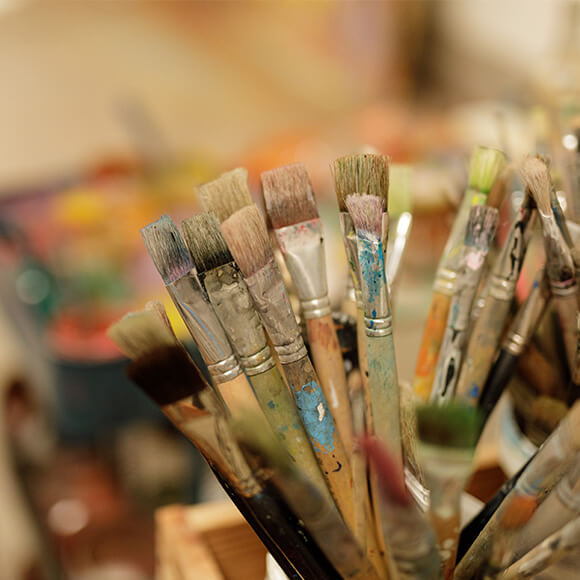 Close-up of colorful paintbrushes in an art studio for creative activities.