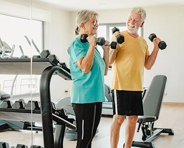 senior couple lifting weights