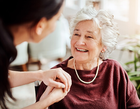 Holding senior woman's hand