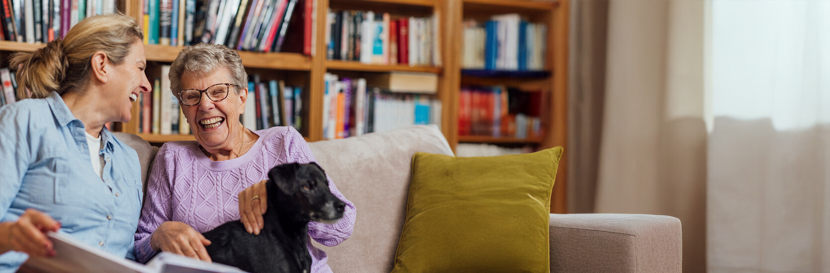 two women laughing in the library