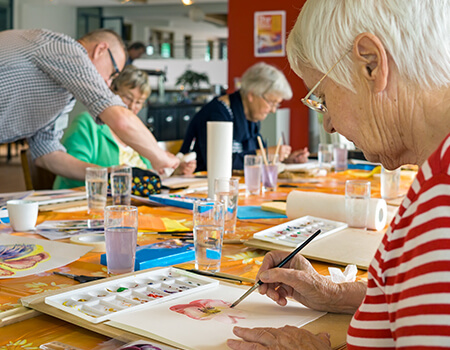 senior woman in painting class