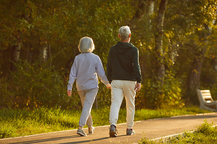 senior couple walking on an outdoor path