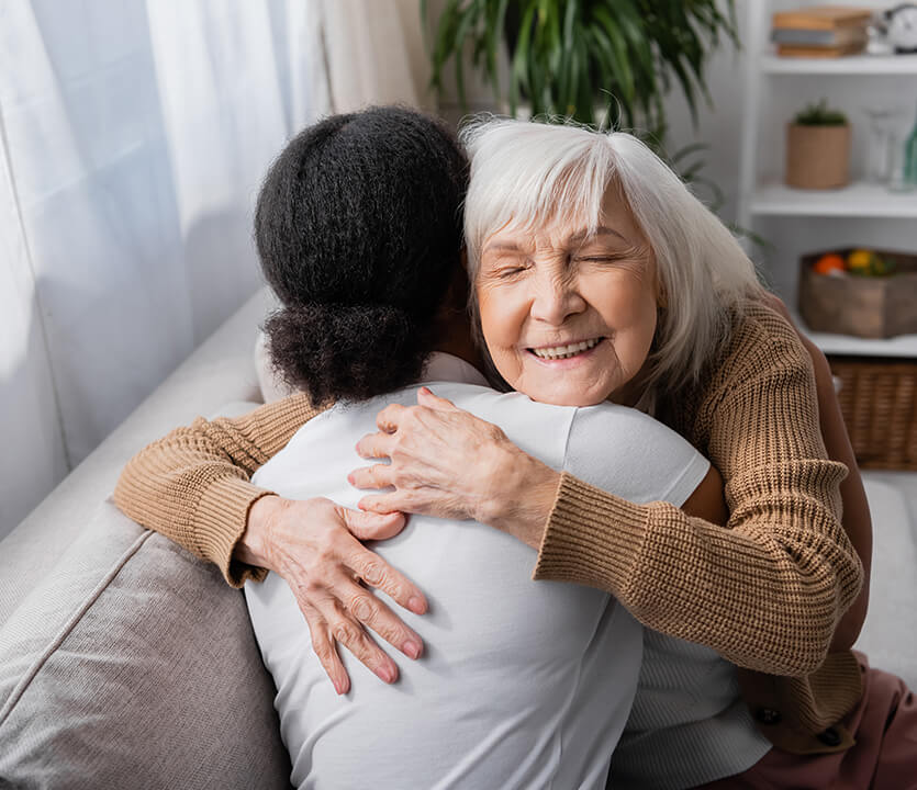 senior woman giving out a hug