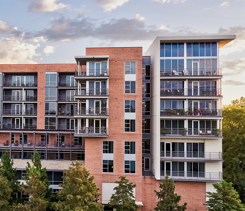 Contemporary senior living community building with balconies.