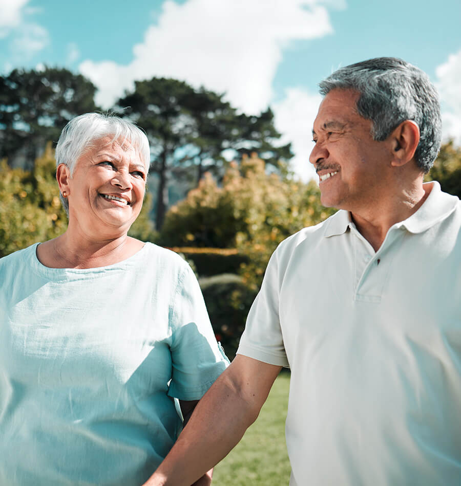 Seniors holding hands taking a stroll in the park