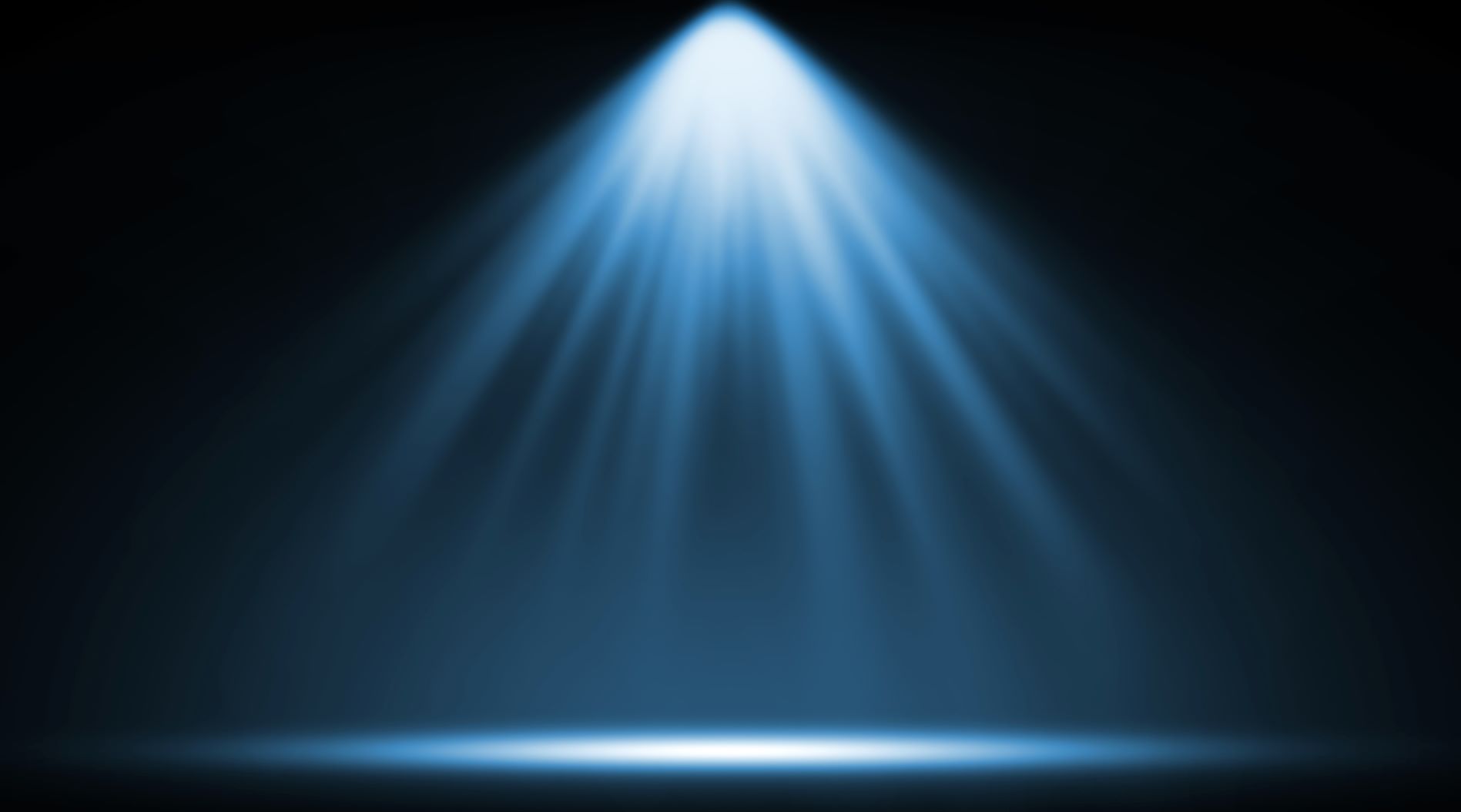 A focused blue spotlight illuminating a dark empty stage with rays spreading outward.